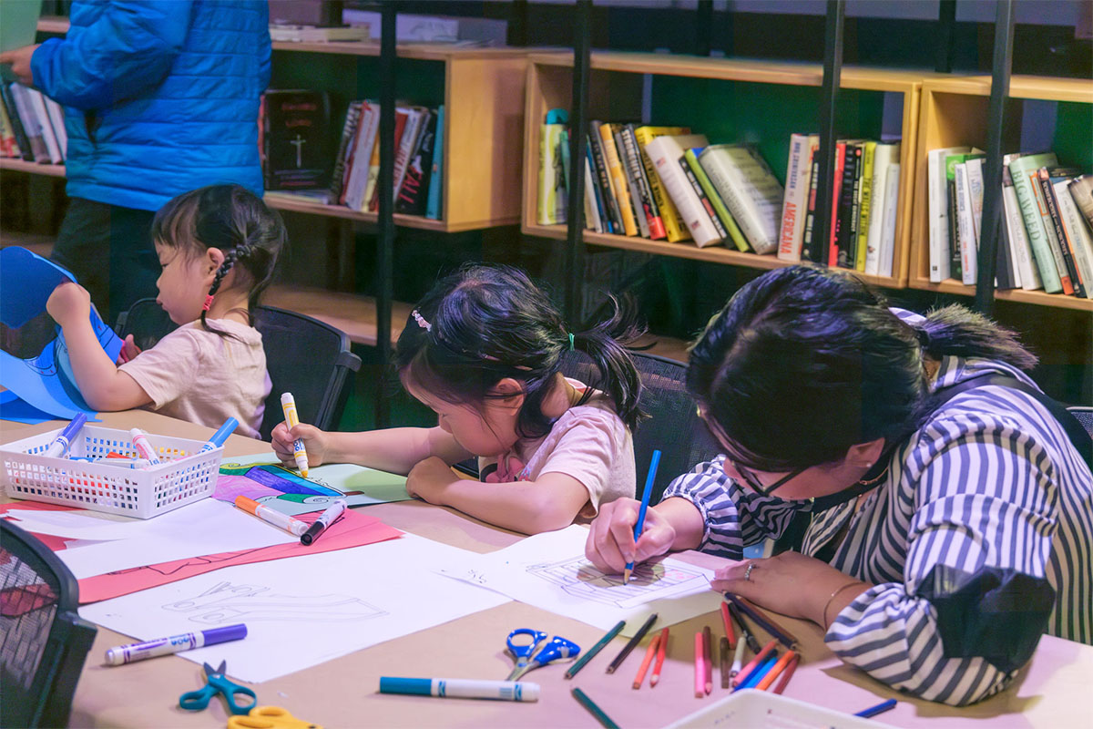 Children with colorful pens and paper work on art at a table