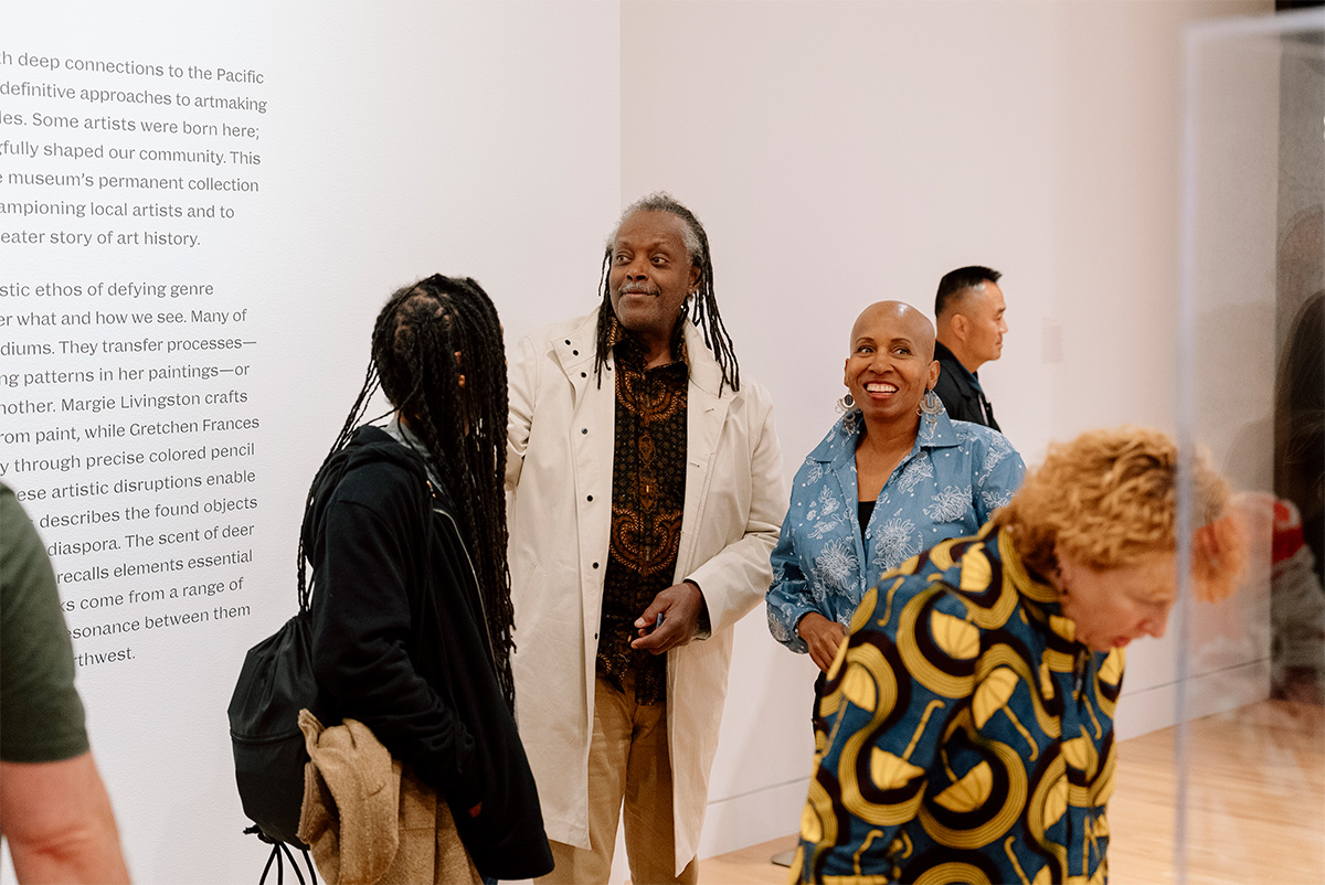 People chatting and looking about in an art gallery space