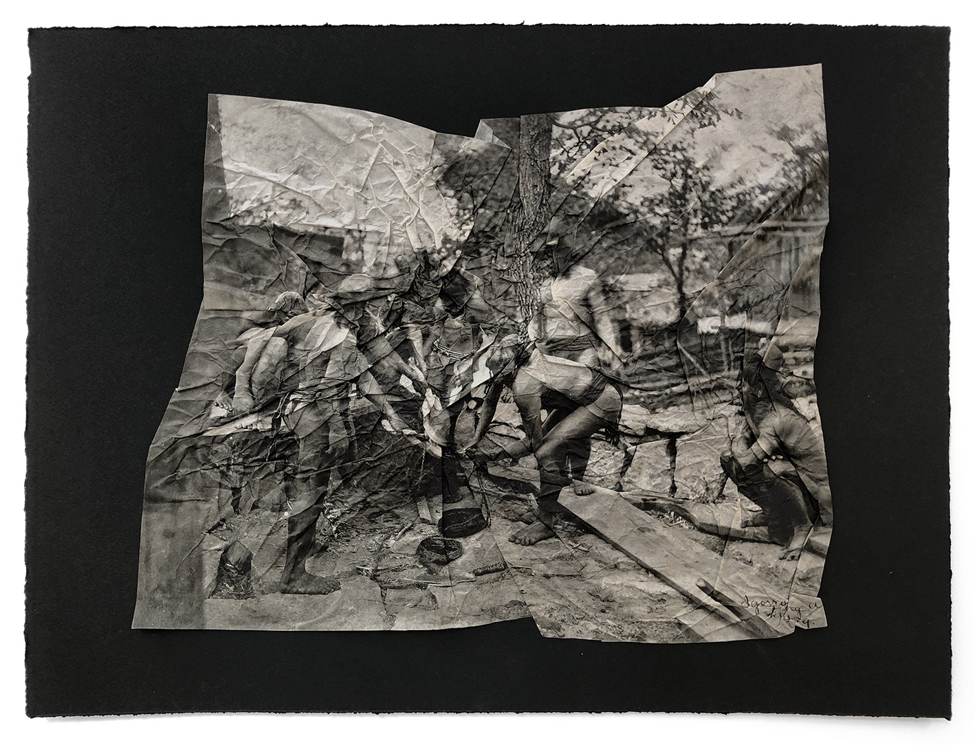 A crumpled print of an photo of people in a rural scene