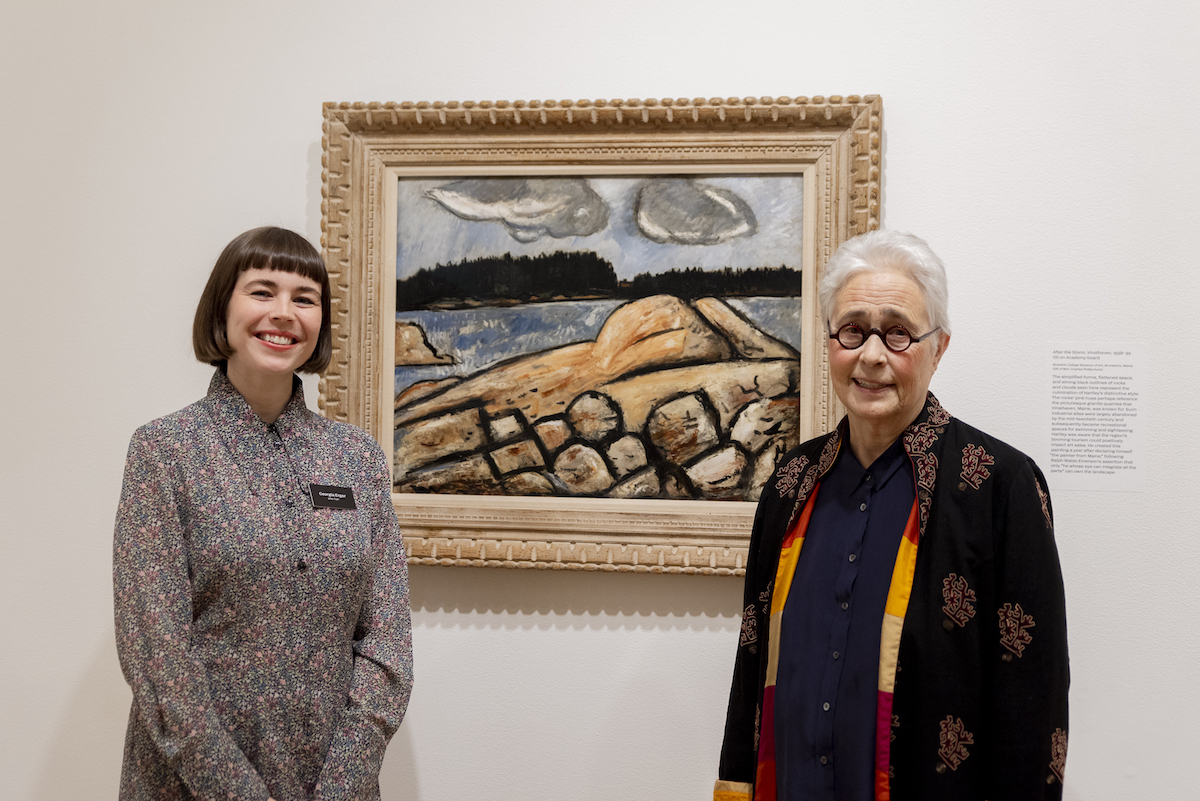 Frye curator Georgia Erger and artist Katherine Bradford stand in front of a painting by Marsden Hartley