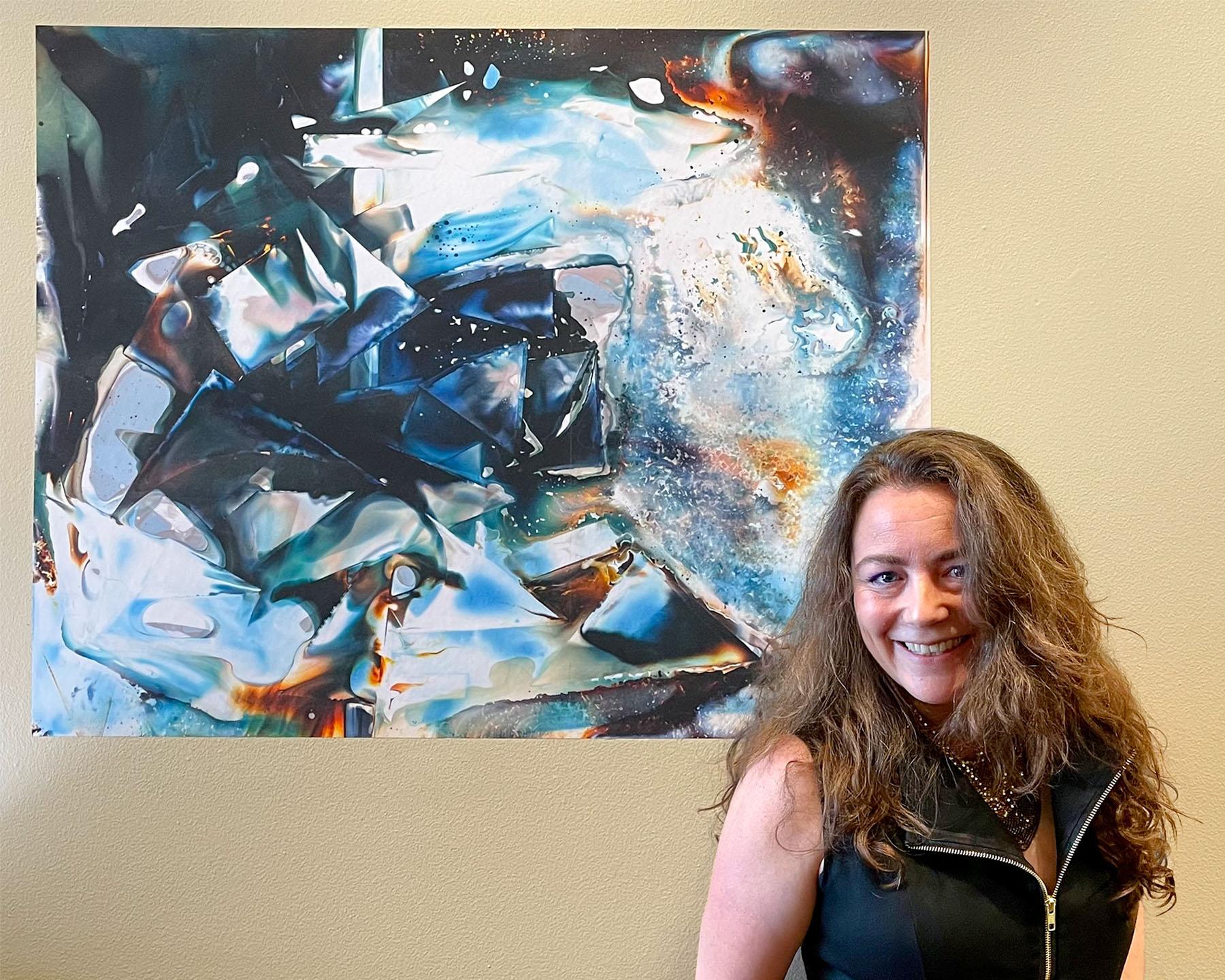 Rachel Wolf in front of Summer Water at a solo show at LightBox Photographic Gallery