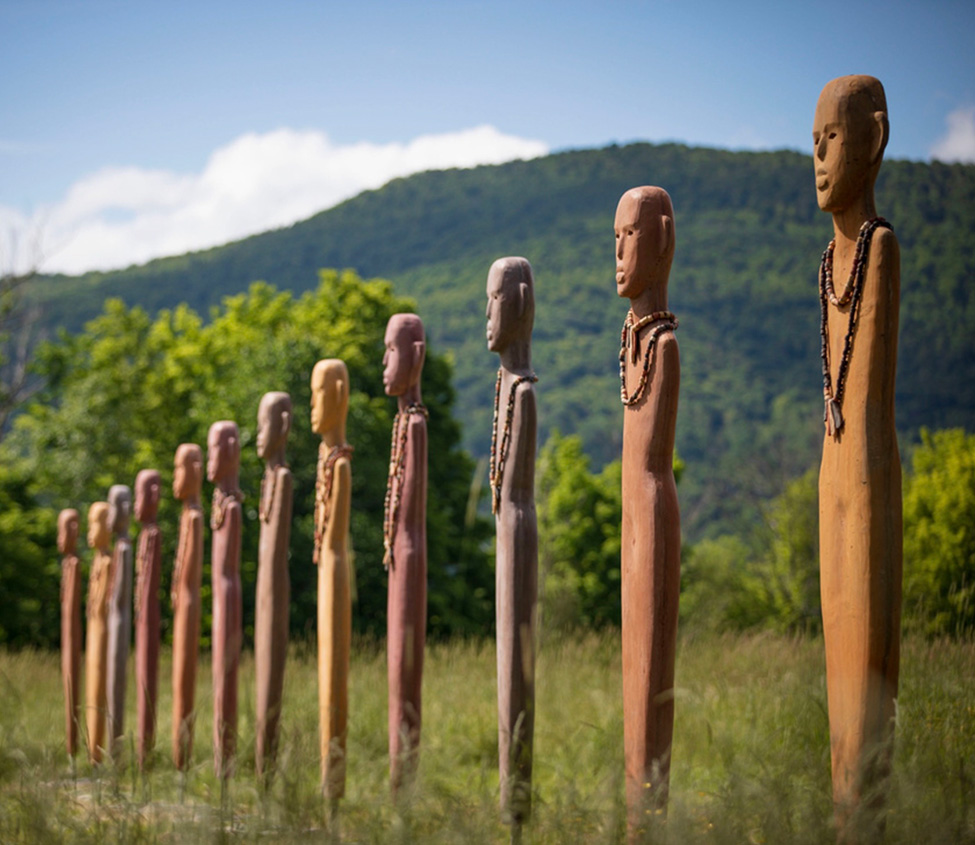 Wooden figures standing in a field