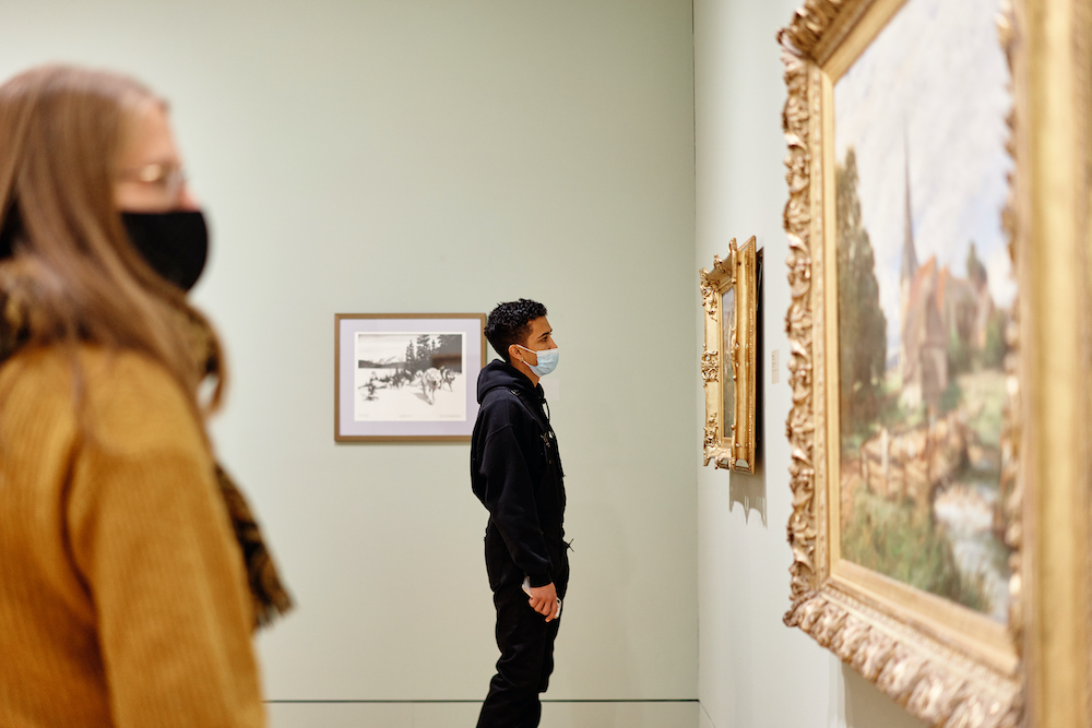 Patron viewing a painting during Members' Night