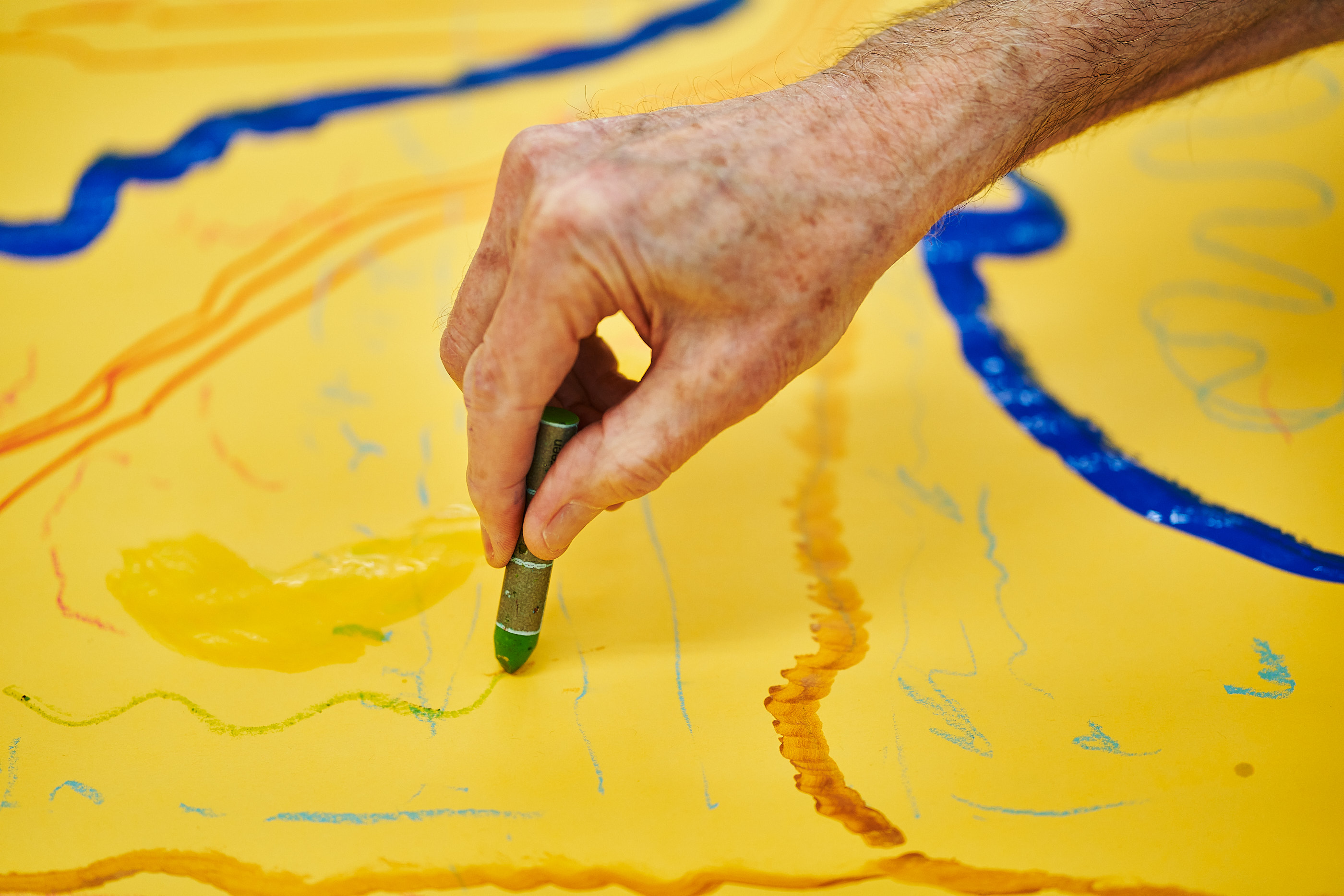 Creative Aging participant working on a group painting