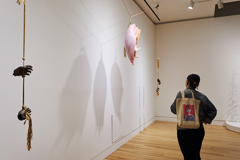 A person looking at an artwork in Kelly Akashi: Formations at the Frye