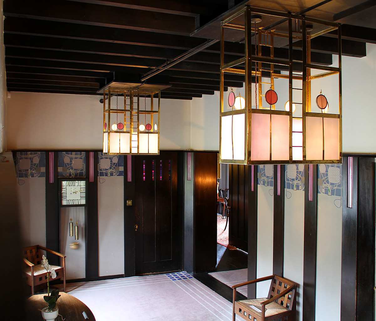 The interior of a fashionably designed house with chandeliers and fixtures with an early twentieth-century aesthetic