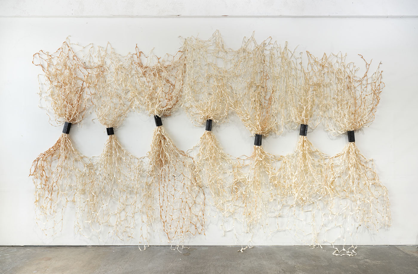 A large, wall-mounted weaving based sculptural artwork