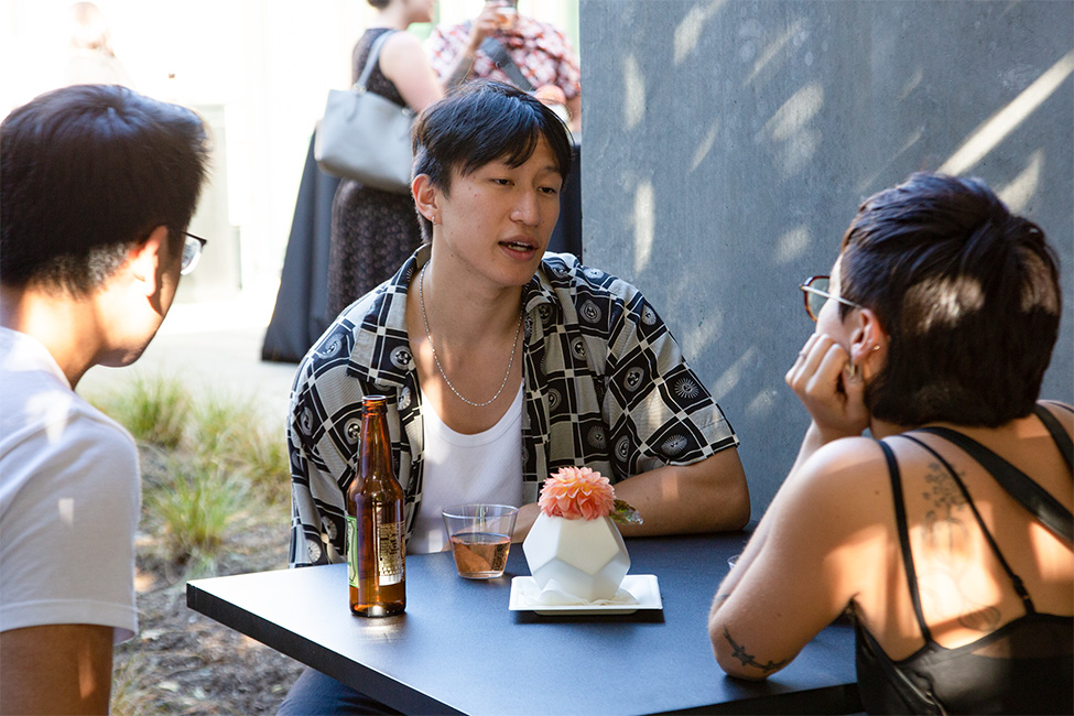 People sitting at a table and chatting in a courtyard