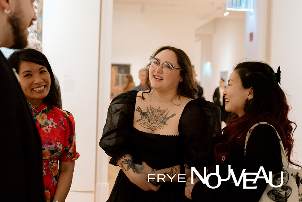 Young people smiling and chatting in a gallery space