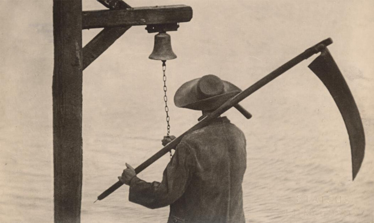 A still from a black and white movie of the back of a person holding a scythe