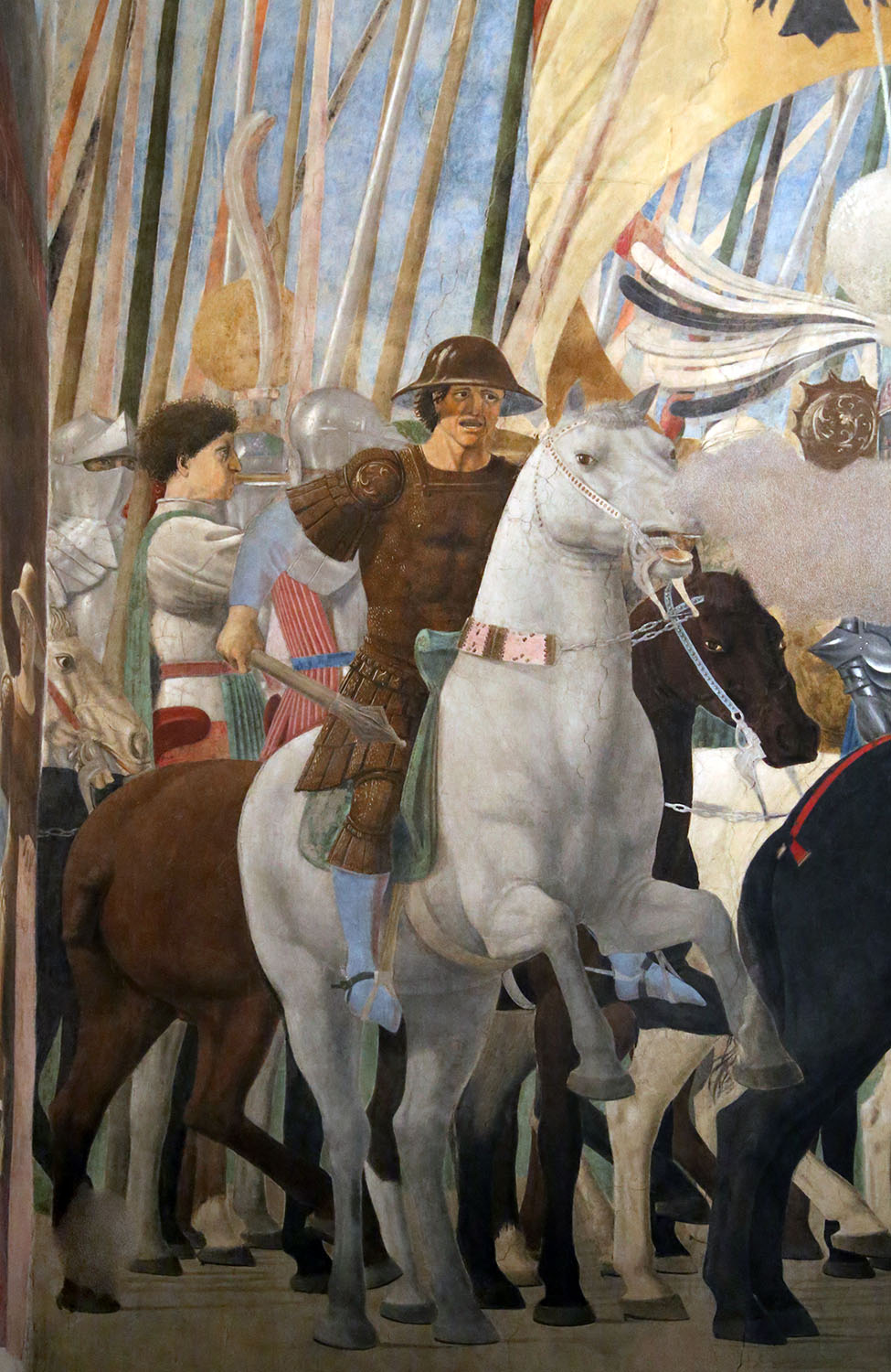 A detail from a larger fresco of a man on a horse in front of an army