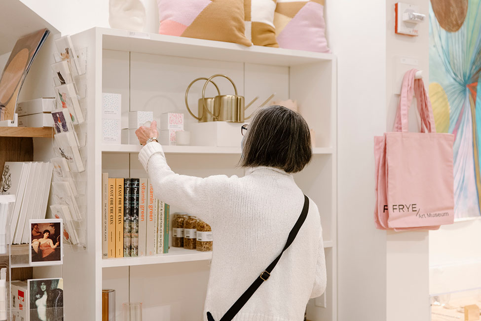 A person checks out an object in the Frye Museum Store