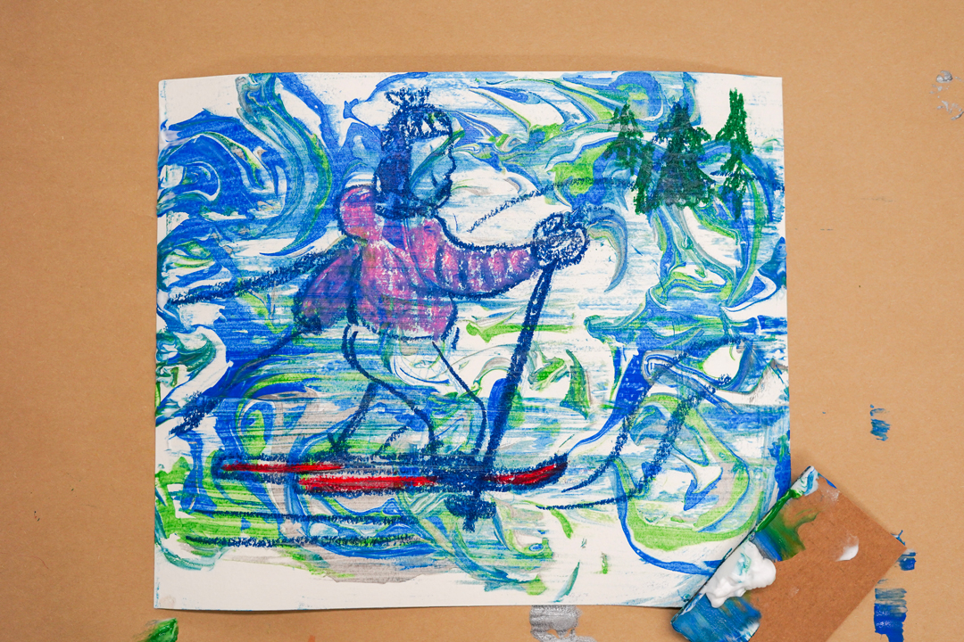 Photo of an artwork showing a skier and trees with a swirl of green and blue over them