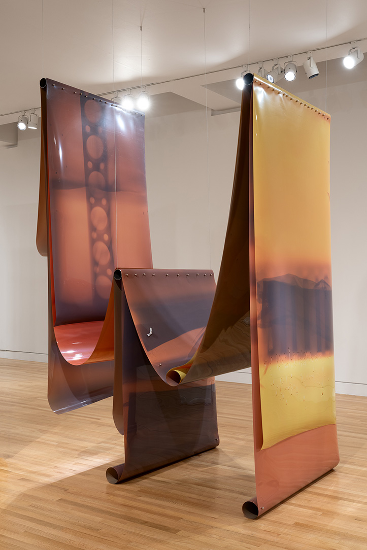 Large sheets of material hung vertically and draped over each other form an artwork