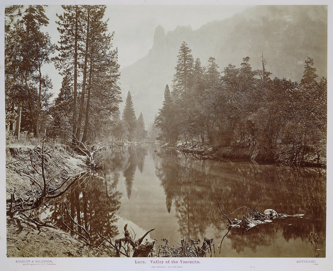 A sepia photograph of a slow-moving river in a high mountain valley
