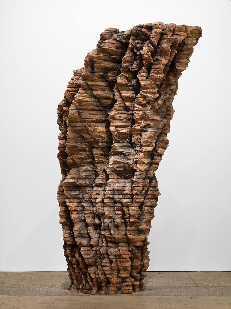 A large, abstract carved wood sculpture