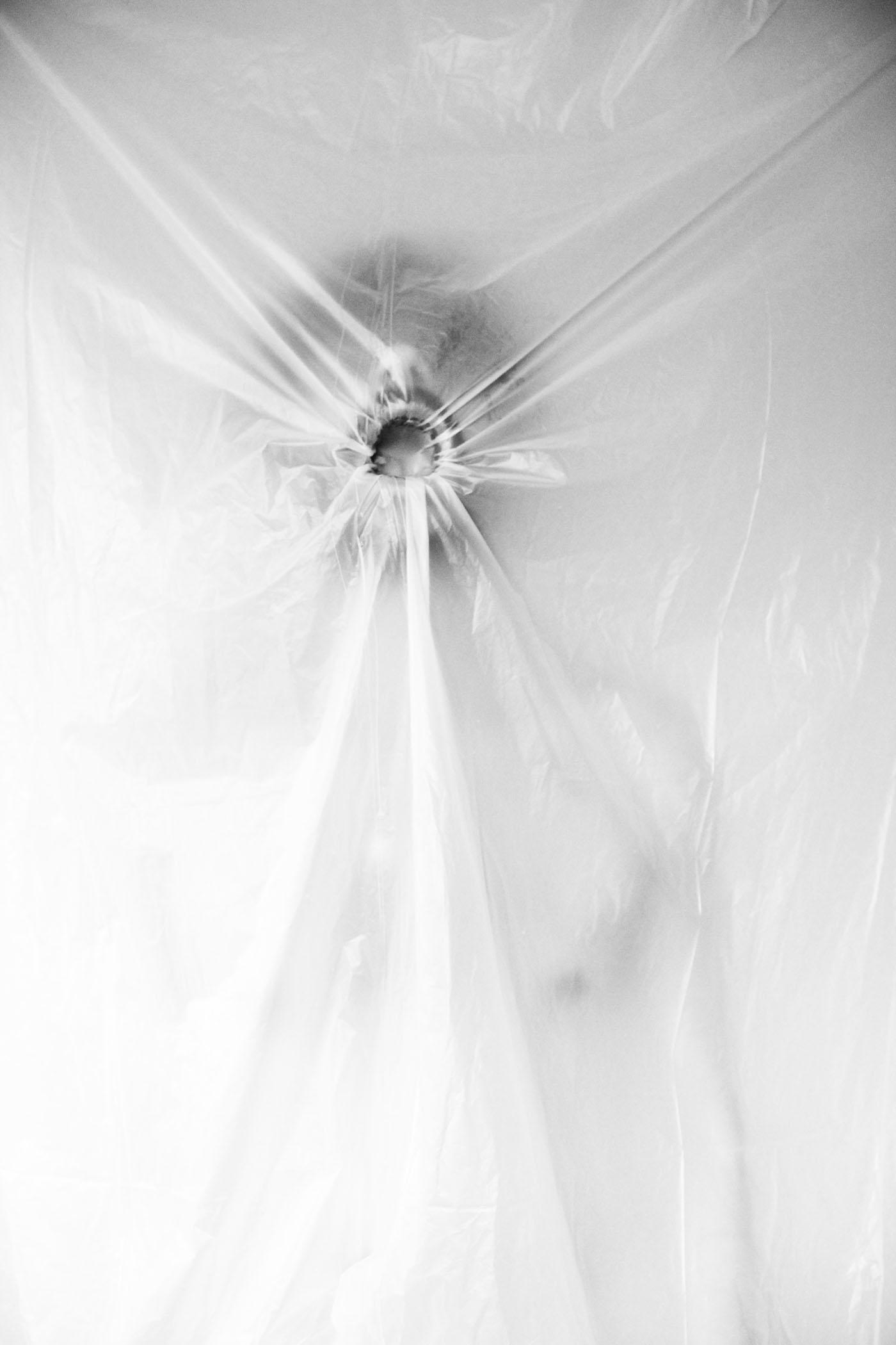 Image of a person breathing in against a transparent sheet