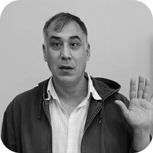 A black and white photo of a man holding up and showing the palm of his hand