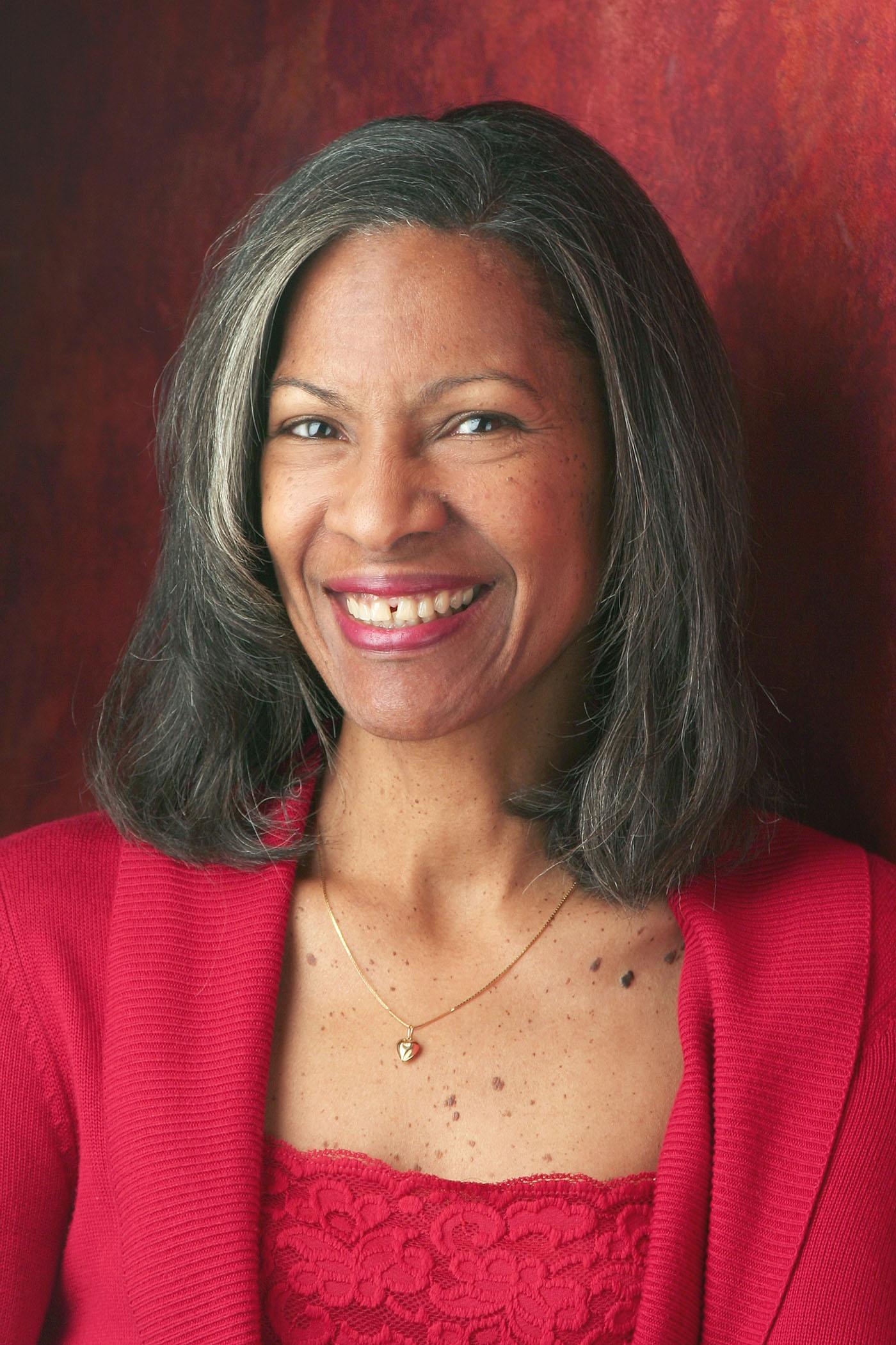 A professional headshot style photograph of a woman