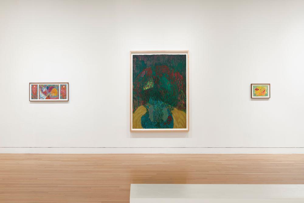 Photograph of a gallery with three paintings hung on a white wall; two smaller paintings are on either side of a large painting