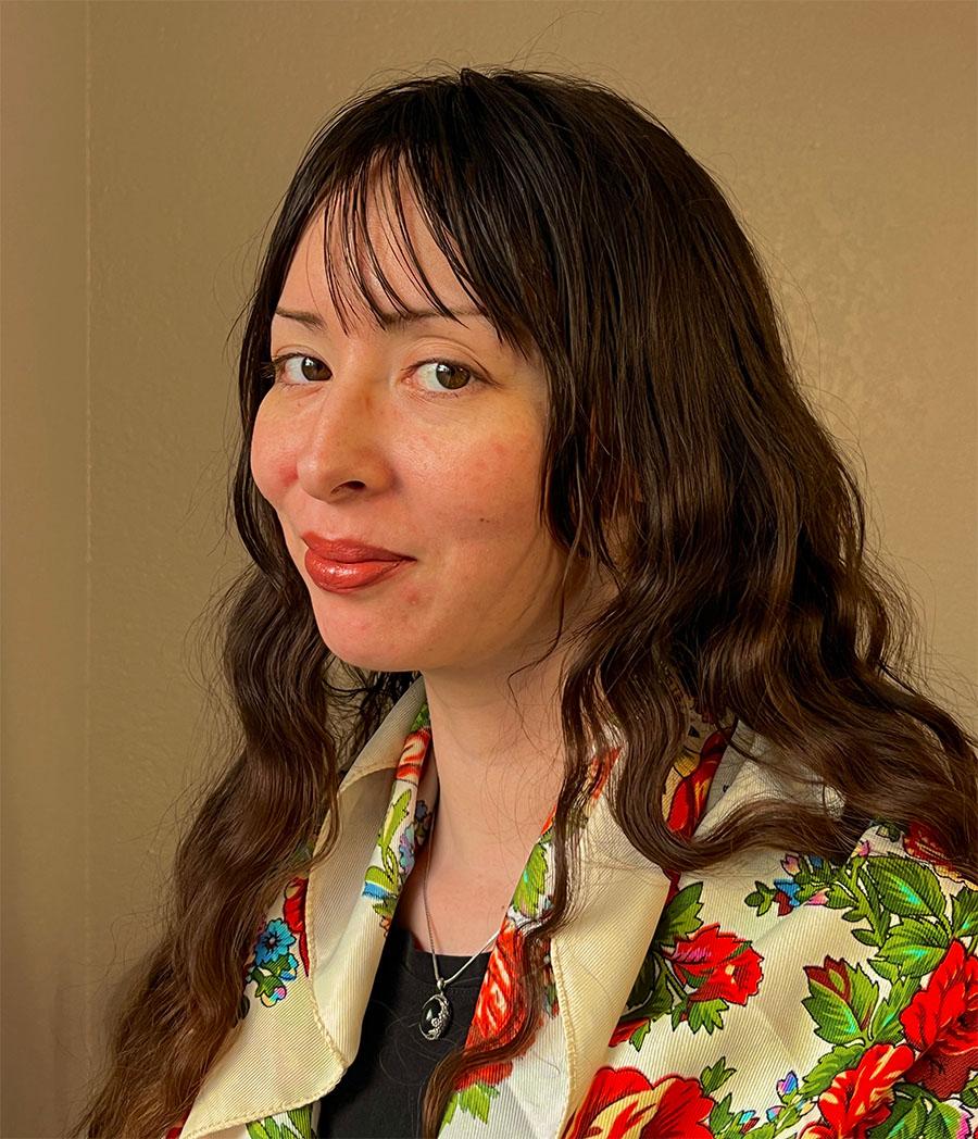 A phone style photo of a person with long hair turned 45 degrees from a camera