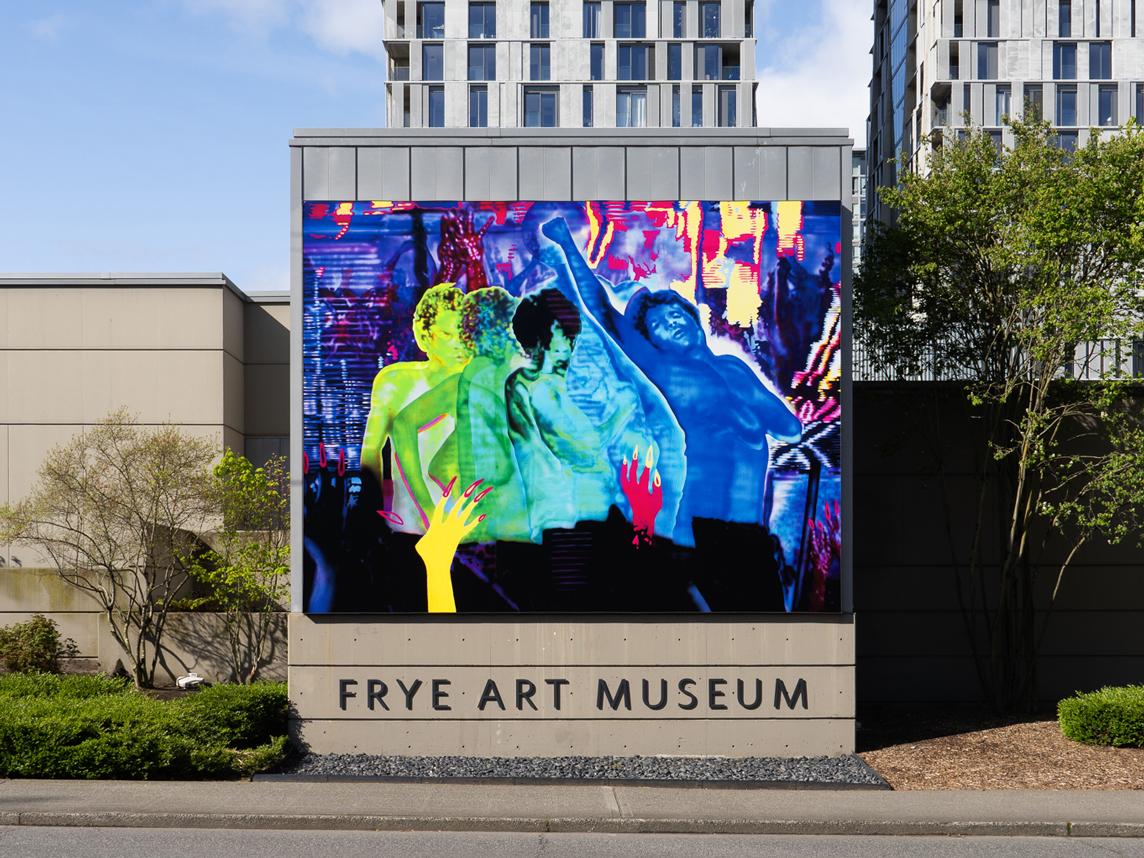 A large, colorful artwork installed on the exterior of a building above the text 'Frye Art Museum'