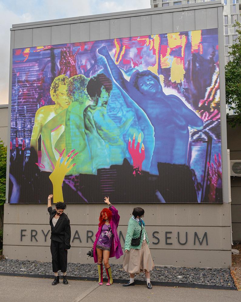 Three people dancing in front of Chloe King's colorful, graphic Boren Banner