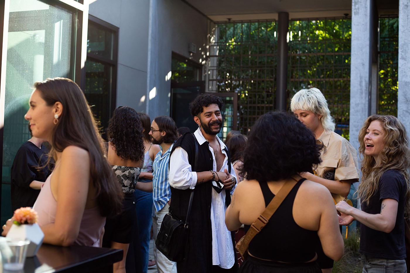 People chatting and drinking in a courtyard