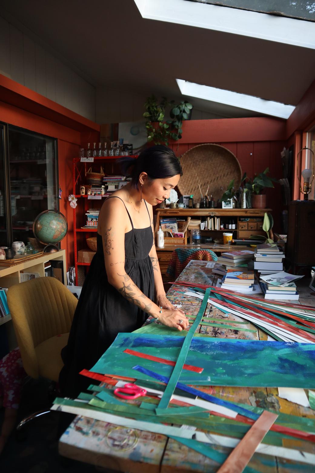 Photo of lexa toledo villanueva working with long stripes of paper on a work table