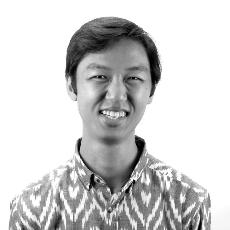 A black and white portrait photo of a younger Asian man