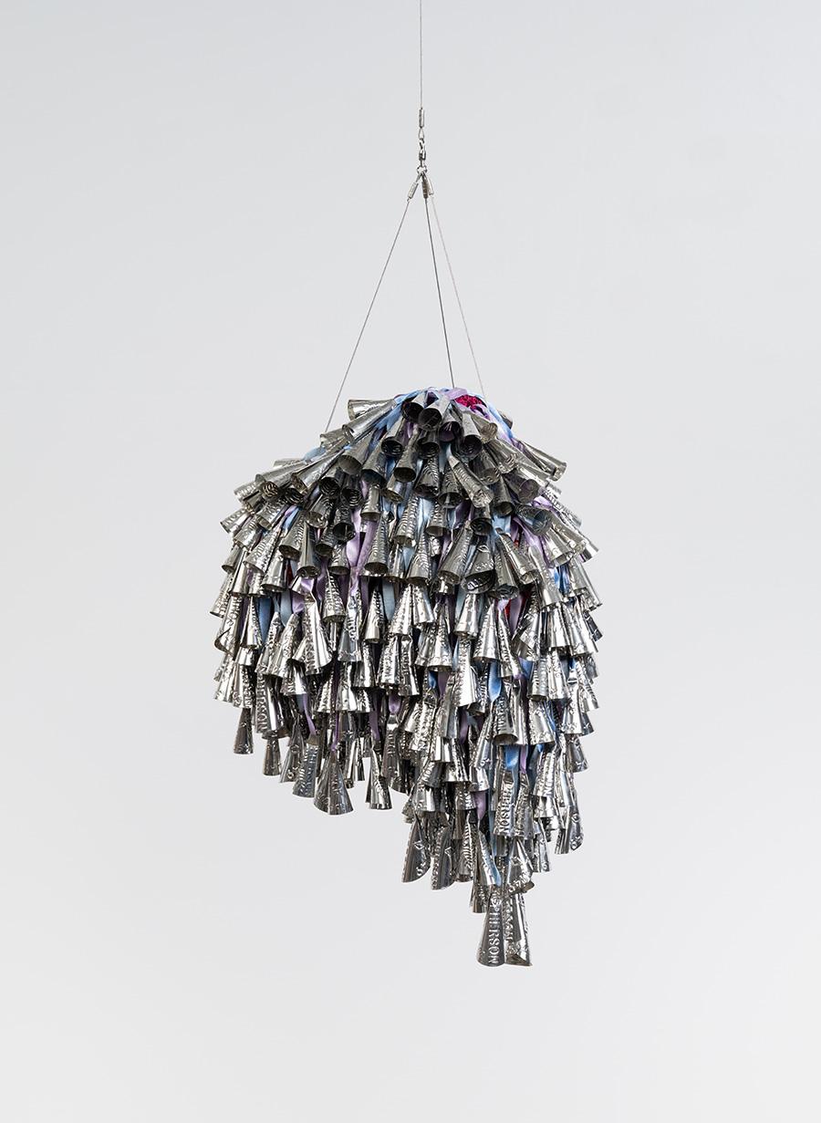 A suspended, metallic three dimensional artwork