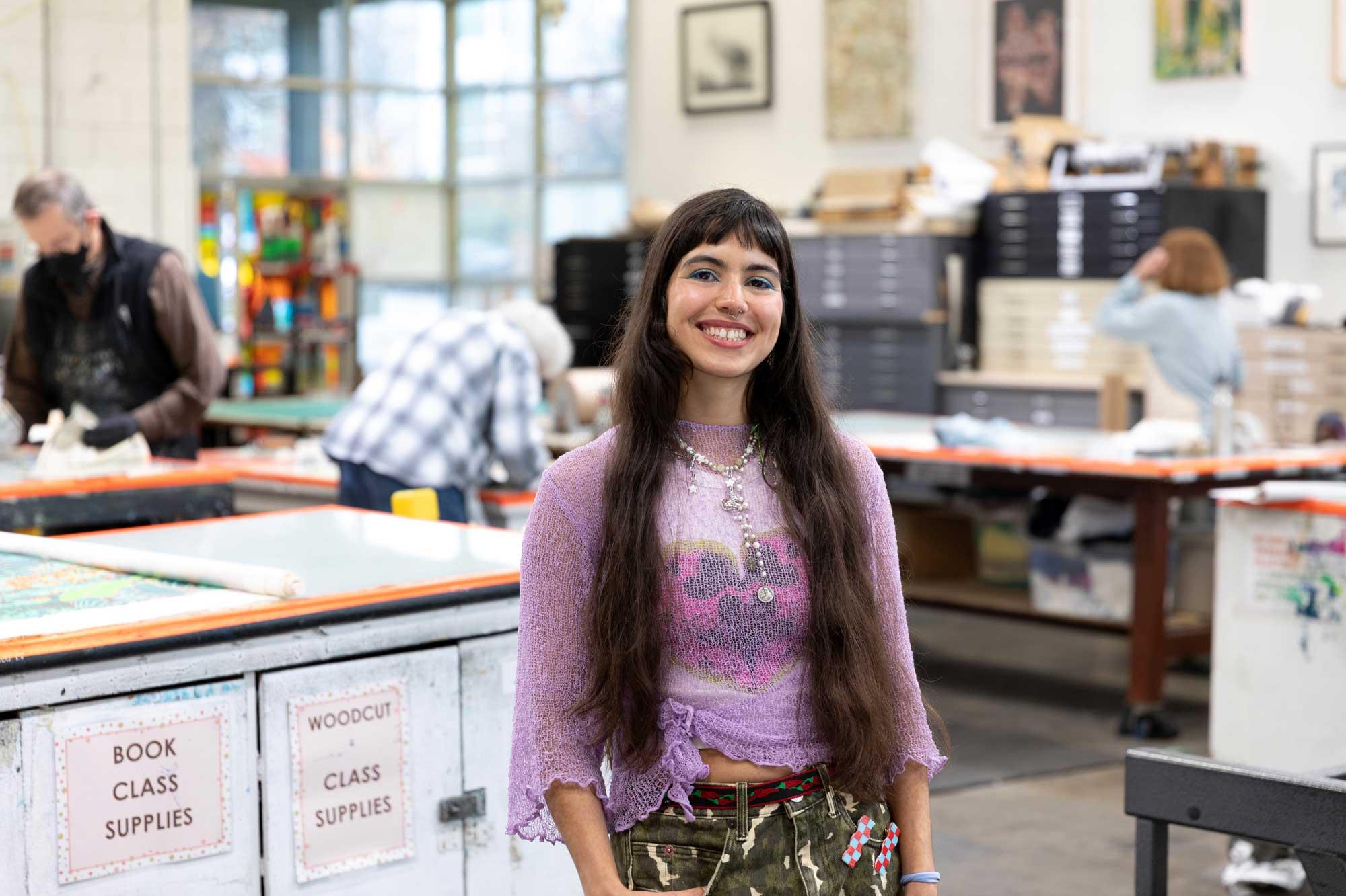 Artist María Zamora standing in a screenprinting studio
