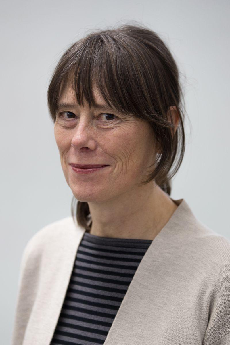 Photo headshot of Mary Jane Knecht, a woman with brown hair pulled back and bangs