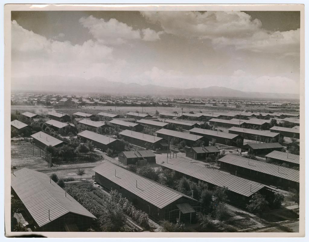 Black and white overhead photo of Poston concentration camp buildings with Riverside Mountains visible in the background